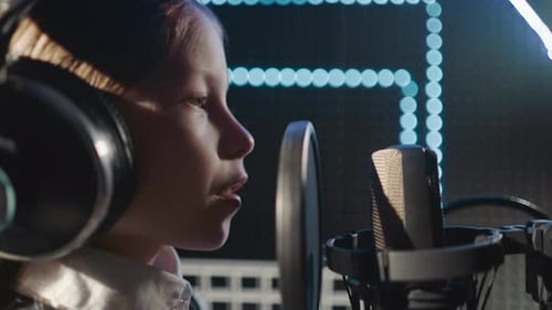 Child Sings into Microphone in Recording Studio