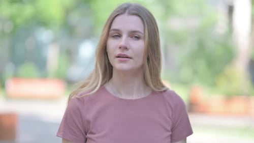 Young Woman Checking Watch While Waiting Outdoors