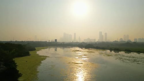 Wide Aerial View of Hazy City River and Urban Skyline