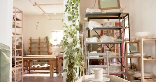 Desks, shelfs and potter's wheel in pottery studio