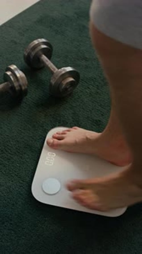 Weighing Feet Stepping on Bathroom Scale