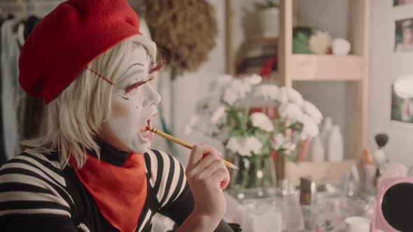 Female Mime Artist Writing Play Script and Practicing Acting in ...