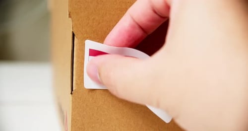 Placing a Made In Hungary Sticker on Box