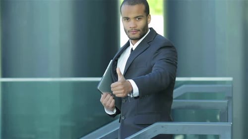 Man in Suit Gives Thumbs Up Outside