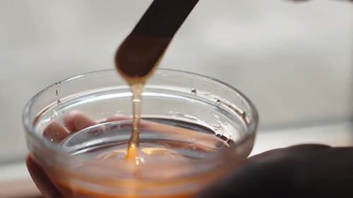 Close Up Of A Person Holding Honey Bowl