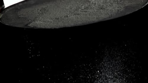 Sifting Powdered Sugar and Flour Creates a Stunning Contrast on a Black Surface