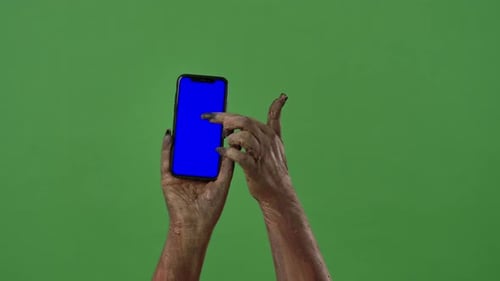 Hands Covered in Brown Material Using Blue Screen Phone