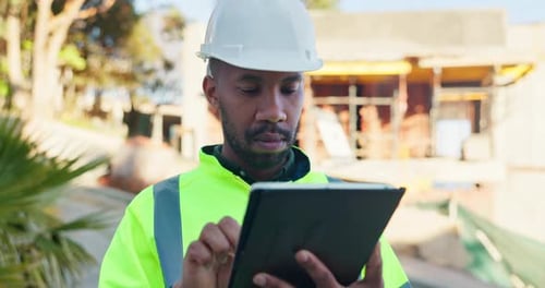 Architect, black man and typing on tablet for construction planning, site inspection
