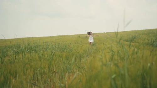 Beautiful Ukrainian Playful Little Girl in White Dress Running Through Green Field Laughing Great