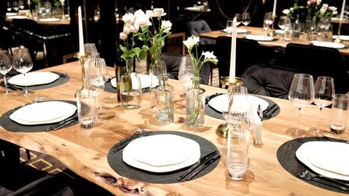 Elegantly made empty dinner tables in a chic restaurant shot with a slider