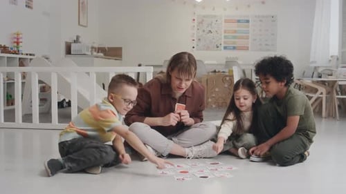 Teacher and Children Playing Matching Game in Classroom