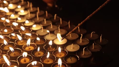Candles Being Lit at Night