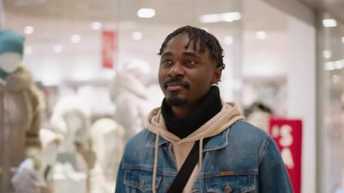 Young Black Man Browsing Denim Jacket Shopping Mall Interior