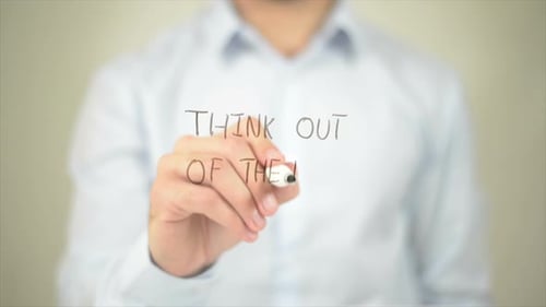 Hand Writing Think Out of the Box on Screen