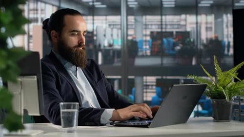 Business Owner in Corporate Office Reviewing Documents