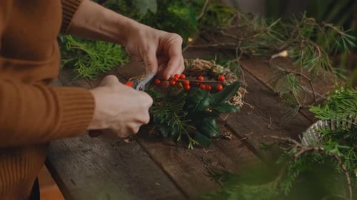 Adult Crafting Festive Christmas Wreath at Home
