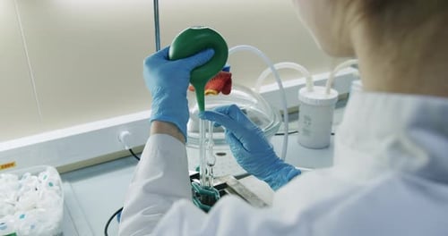 Gloved Hand Working With Lab Equipment