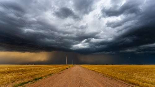 Down A Dusty Road Powerful Storm Clouds Bring Heavy Rain And Lightning