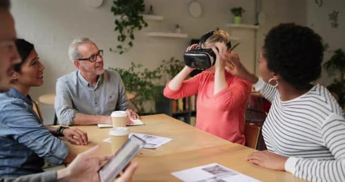 Colleagues Experiencing VR Technology Around Table