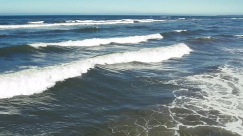 Layers Of Small Ocean Waves Rolling With Drone Flying Low Slow Motion