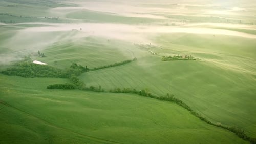 Flying over the foggy Tuscany Italy landscape