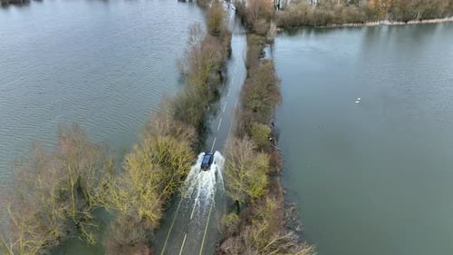 Vehicle Driving Through a Flooded Road Aerial View