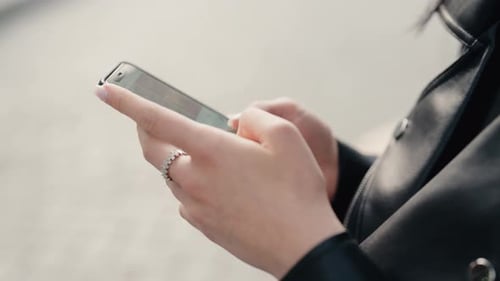 CloseUp of Hands Using Smartphone for Messaging and Communication