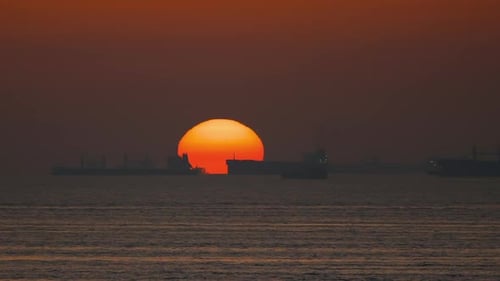 Sun Circle and Cargo Ships At Dusk 2