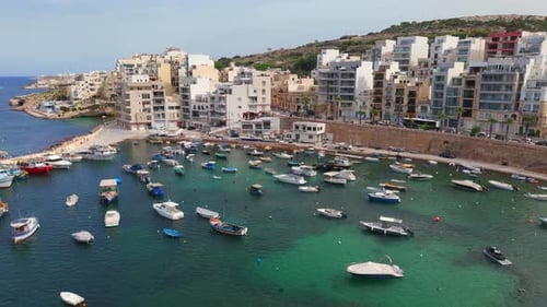 Scenic drone footage flying above St. Paul’s Bay, showcasing its tranquil harbor and scenic Maltese
