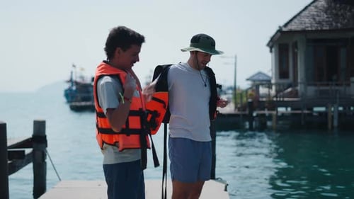 Two Young Friends Getting Ready for a Kayaking Adventure on a Lake in the Middle of Nature