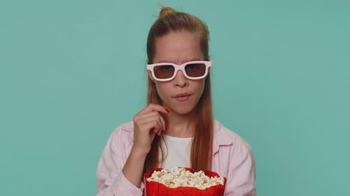 Girl Eating Popcorn Wearing 3D Glasses