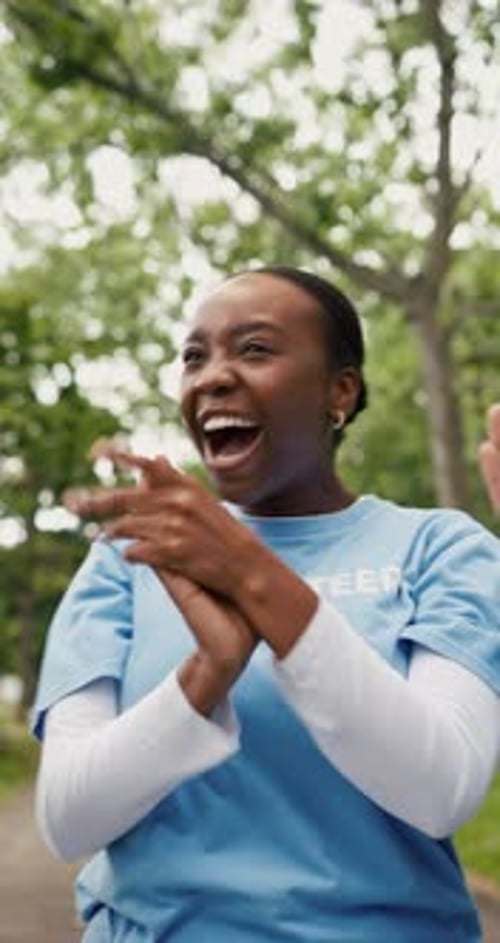 Excited, woman and volunteer with applause in park for good news with charity success