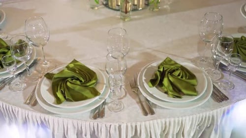 Decorated Wedding Table with Plates and Green Napkins