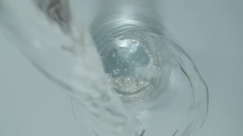 Water Pouring into a Clear Glass, Close Up
