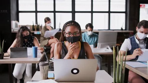 Young Business People with Face Masks Working Indoors in Office, Coronavirus Concept