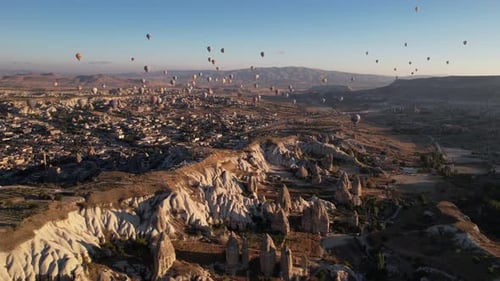 Cappadocia, Turkey. Drone Shot of Hot Air Balloons Flying Above Beautiful Landscape on Sunny Morning