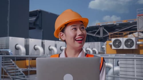 Close Up Of Asian Female Engineer Working On A Laptop On Rooftop HVAC