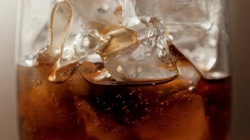 Carbonated Drink filling Glass with Bubbling Liquid