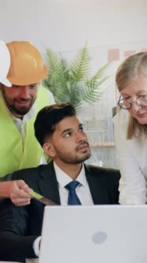 Close Up of Pleasant Satisfied Experienced Professional Male and Female Engineers in Vests and