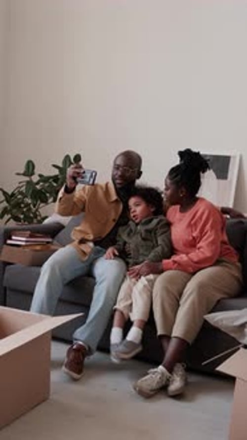 Happy Family Taking Selfie in New Apartment