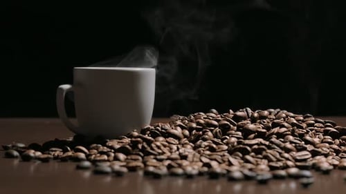 Steaming Coffee Cup and Roasted Beans