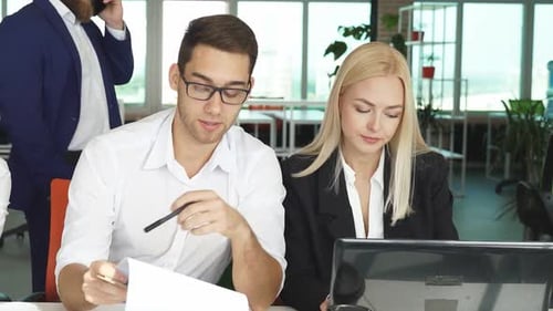 Young Adults Collaborate in a Modern Office