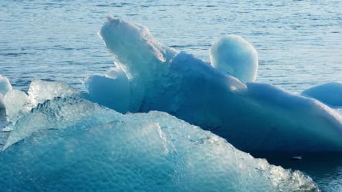 Glacial Iceberg Floating in Ocean Waters on Bright Day