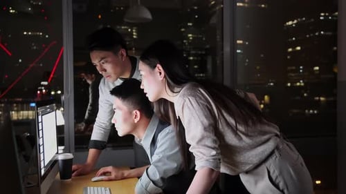 Excited Teamwork at Night in Modern Office Building