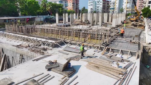 Aerial View Concrete Pouring By Workers at a Construction Site Foundation