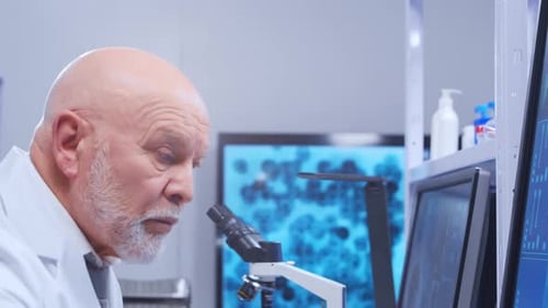 Senior Scientist Using Microscope in Modern Laboratory