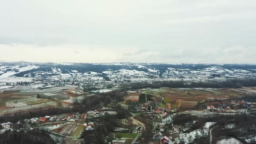 Aerial view of the snowy arable land valley, drone 4K