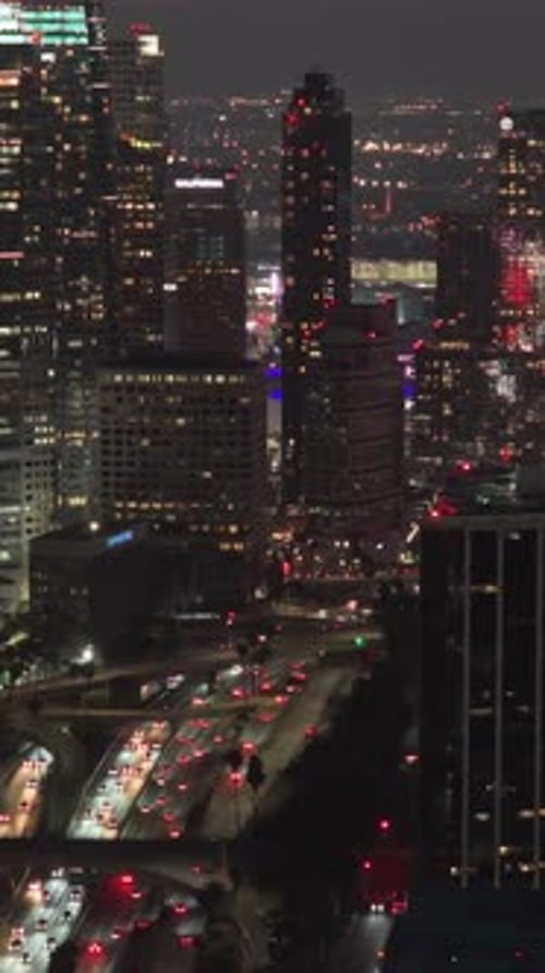 Nighttime Cityscape Showing Downtown Los Angeles Skyscrapers with Illuminated Office Windows and