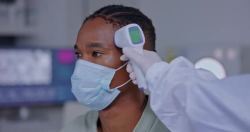 Thermometer, doctor and covid patient with a face mask in a hospital checking temperature
