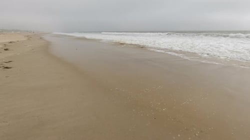 Sandy beach and ocean with waves.